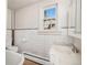 Clean bathroom with white tile, a bathtub, and a pedestal sink at 2801 W Dartmouth Ave, Denver, CO 80236