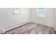 Well-lit bedroom with hardwood floors and ample natural light at 2801 W Dartmouth Ave, Denver, CO 80236