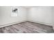 Bright bedroom with wood-look floors and large window at 2801 W Dartmouth Ave, Denver, CO 80236