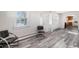 Inviting entryway with wood-look floors and view to kitchen at 2801 W Dartmouth Ave, Denver, CO 80236