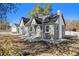 Charming bungalow with gray siding, a new roof, and a spacious yard at 2801 W Dartmouth Ave, Denver, CO 80236