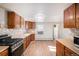 Galley kitchen with wood cabinets and stainless steel appliances at 2801 W Dartmouth Ave, Denver, CO 80236
