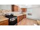 Updated kitchen with wood cabinets and stainless steel appliances at 2801 W Dartmouth Ave, Denver, CO 80236