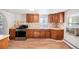 Efficient kitchen featuring wood cabinets and modern appliances at 2801 W Dartmouth Ave, Denver, CO 80236