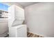 Small laundry room with stackable washer and dryer at 2801 W Dartmouth Ave, Denver, CO 80236
