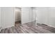 Bright living room featuring wood-look floors and access to other rooms at 2801 W Dartmouth Ave, Denver, CO 80236