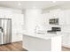 Bright kitchen featuring white cabinets and quartz countertops at 9139 Pitkin St, Commerce City, CO 80022