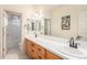 Bathroom with double vanity, large mirror, and separate tub and shower at 6236 Oxford Peak Ln, Castle Rock, CO 80108