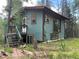 Rustic cabin nestled in a wooded area, offering a tranquil atmosphere at 106 Brook Rd, Evergreen, CO 80439