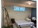 Unfinished basement with a bed, shelving and ample storage space at 106 Brook Rd, Evergreen, CO 80439