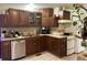 Dark wood cabinetry, stainless steel dishwasher and gas range at 106 Brook Rd, Evergreen, CO 80439
