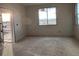 Unfinished room with large window and door at 2283 Serenidad St, Brighton, CO 80601