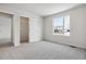 Bright bedroom featuring grey carpet and a double-door closet at 8425 Vona Ln, Littleton, CO 80125