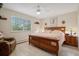 Main bedroom with a king-size bed, wood furniture, and large window at 9340 E Center Ave # 2C, Denver, CO 80247
