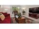 Living room with red couch, two armchairs, and a view of the balcony at 9340 E Center Ave # 2C, Denver, CO 80247