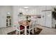Bright kitchen with white cabinets and a dining area at 9340 E Center Ave # 2C, Denver, CO 80247