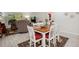 Charming dining area with wood table and white chairs, offering a view of the living room at 9340 E Center Ave # 2C, Denver, CO 80247