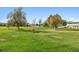 Expansive green space with mature trees and landscaping at 9340 E Center Ave # 2C, Denver, CO 80247