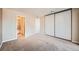 Bedroom with mirrored closet and access to bathroom at 14904 E Hampden Cir # C7, Aurora, CO 80014