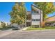 Front view of townhouse building with parking and landscaping at 14904 E Hampden Cir # C7, Aurora, CO 80014