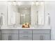 Double vanity bathroom with modern finishes and large mirror at 10860 Lyric St, Lone Tree, CO 80134