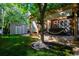 Landscaped backyard with shed and hot tub at 716 Ridgemont Pl, Highlands Ranch, CO 80126