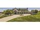 White golf clubhouse with green roof and landscaping at 2058 S Haleyville Way, Aurora, CO 80018