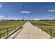 Pathway between two soccer fields with goals and lights at 2058 S Haleyville Way, Aurora, CO 80018