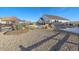 Landscaped backyard with gravel and partial snow at 23827 E Rockinghorse Pkwy, Aurora, CO 80016