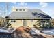 Inviting home exterior with a front walkway, snow-dusted landscaping, and a clear blue sky at 6864 Woodchuck Way, Evergreen, CO 80439