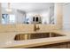 Modern kitchen sink and faucet with stylish tile backsplash at 7373 E Iowa Ave # 1101, Denver, CO 80231