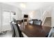 Dining area with a view into the living room and staircase at 7373 E Iowa Ave # 1101, Denver, CO 80231