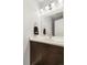 Clean bathroom with dark wood vanity and a large mirror at 7373 E Iowa Ave # 1101, Denver, CO 80231