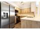 Modern kitchen with stainless steel appliances and light wood cabinets at 7373 E Iowa Ave # 1101, Denver, CO 80231