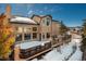 Elevated view of a spacious backyard deck with snow and trees at 3891 Windchant Cir, Castle Rock, CO 80104