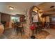 Basement wet bar with stone archway and bar seating at 3891 Windchant Cir, Castle Rock, CO 80104