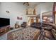 Inviting living room with a stone fireplace, leather furniture, and large windows at 3891 Windchant Cir, Castle Rock, CO 80104