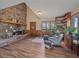 Living room features a stone fireplace and hardwood floors at 6590 Ridgeview Dr, Morrison, CO 80465