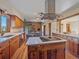 Open kitchen with island, wood cabinets, and views at 6590 Ridgeview Dr, Morrison, CO 80465