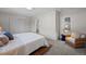 Spacious bedroom with king-size bed, sitting chair, and en-suite bathroom at 8447 W Dakota Ave # D, Lakewood, CO 80226