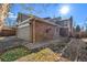 Brick and gray sided home with a two-car garage and landscaping at 1581 S Syracuse St, Denver, CO 80231