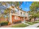 Tan and brick townhouse exterior with landscaping and a paved walkway at 1199 S Waco St # E, Aurora, CO 80017