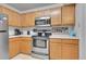 Stainless steel appliances and wood cabinets in kitchen at 1199 S Waco St # E, Aurora, CO 80017