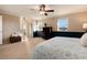 Main bedroom with ceiling fan, dark blue wainscoting, and carpet at 4451 E Lake N Cir, Centennial, CO 80121