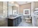 Elegant bathroom with double vanity, marble countertop, and patterned tile floor at 965 N Pennsylvania St, Denver, CO 80203