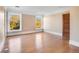 Large bedroom with hardwood floors and two large windows at 965 N Pennsylvania St, Denver, CO 80203