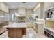 Modern kitchen with large island and stainless steel appliances at 965 N Pennsylvania St, Denver, CO 80203