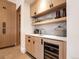 Modern wet bar with wood cabinets, quartz countertops, and wine cooler at 27 Boulder Cir, Breckenridge, CO 80424