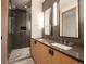 Modern bathroom with double vanity, large shower, and stylish wood cabinets at 27 Boulder Cir, Breckenridge, CO 80424
