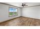 Simple bedroom with large window and hardwood floors at 15 S County Road 197, Byers, CO 80103